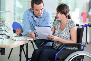 Image of a woman in a wheel chair in a working environment