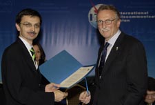 Director elect of the TSB, Mr Malcolm Johnson  receiving his letter of appointment from the Conference Chairman, Tanju ataltepe