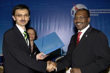Secretary-General elect receiving his letter of appointment from the Conference Chairman, Tanju ataltepe