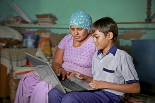 Mother and Son using a laptop at home