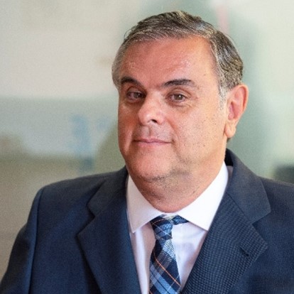 Jesús Hernández Galán, white male with grey hair, wearing a navy suit and blue checkered tie. 