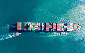 Aerial view of cargo ship carrying container