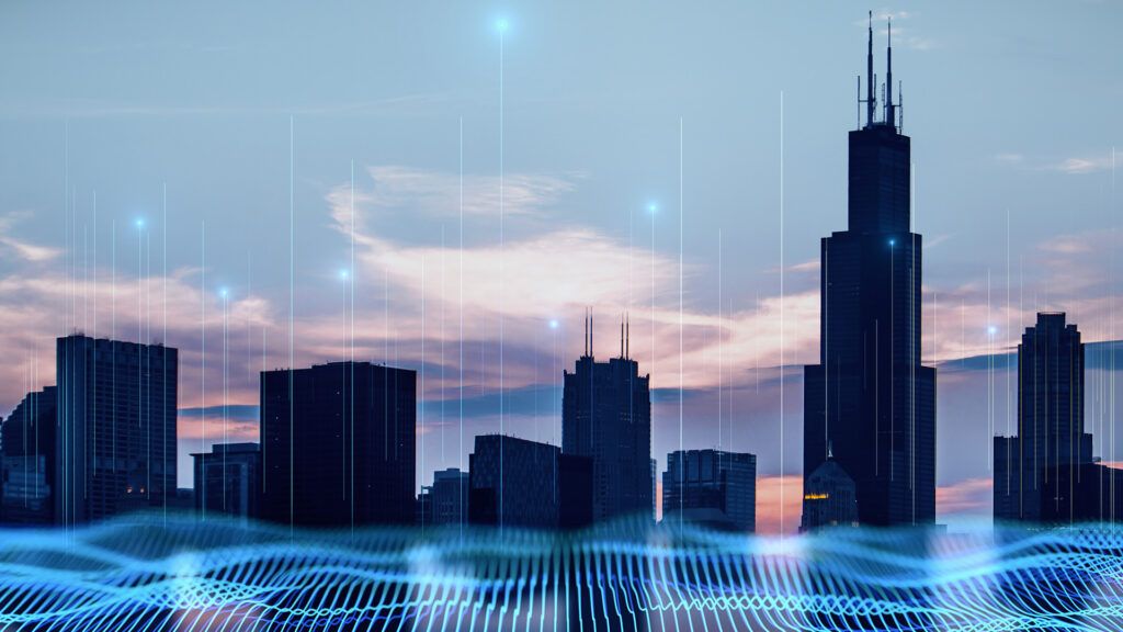 Blue digital wavy wires and antennas on night city skyscraper. Adobe Stock