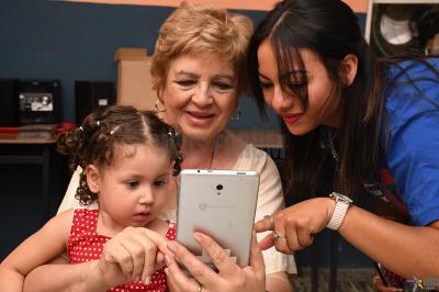 Senior citizens and children united by the technology